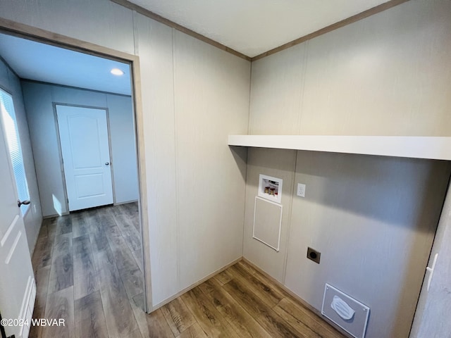 clothes washing area featuring washer hookup, hardwood / wood-style floors, crown molding, and electric dryer hookup