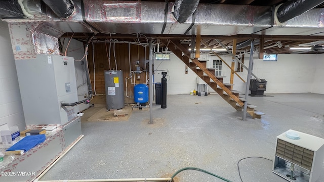 1945 Eagle Valley Rd, Beech Creek, PA 16822 - basement with water heater, a water pressure tank, stairway, concrete block wall, and a water softener
