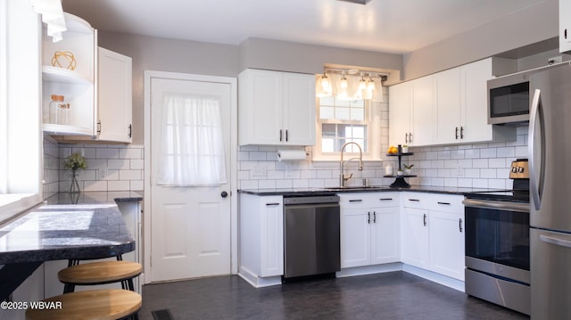 1945 Eagle Valley Rd, Beech Creek, PA 16822 - kitchen with appliances with stainless steel finishes, open shelves, decorative backsplash, white cabinets, and dark countertops