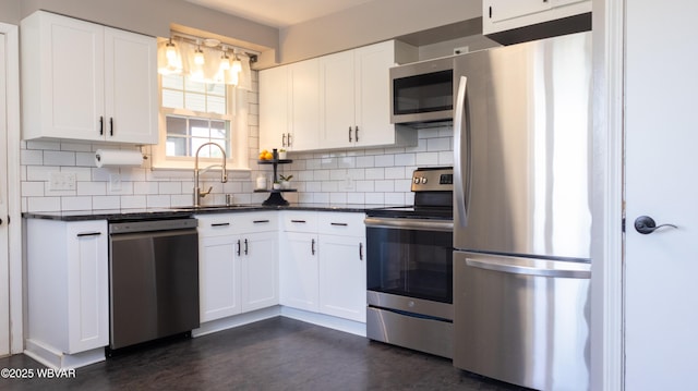 1945 Eagle Valley Rd, Beech Creek, PA 16822 - kitchen with stainless steel appliances, dark countertops, backsplash, and white cabinetry