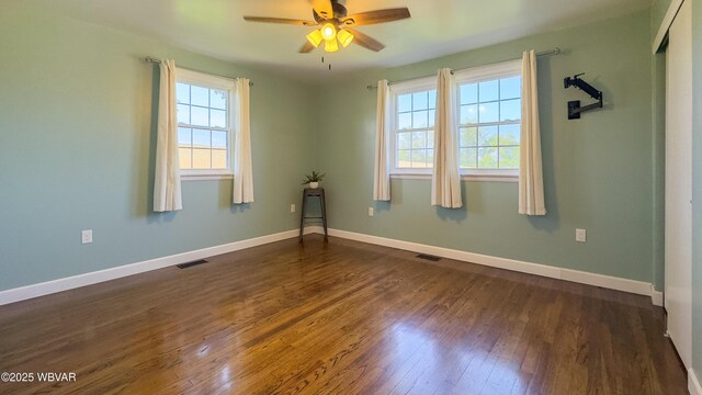 1945 Eagle Valley Rd, Beech Creek, PA 16822 - empty room featuring healthy amount of natural light, dark wood finished floors, and a ceiling fan