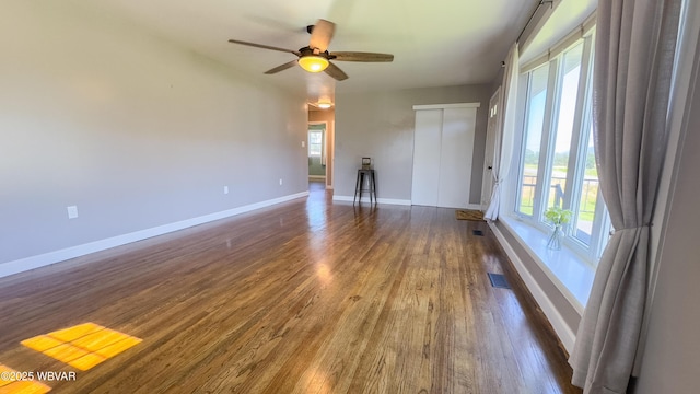 1945 Eagle Valley Rd, Beech Creek, PA 16822 - unfurnished living room featuring healthy amount of natural light, wood finished floors, and ceiling fan