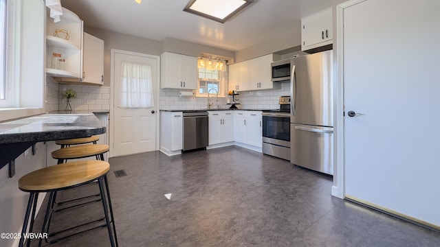 1945 Eagle Valley Rd, Beech Creek, PA 16822 - kitchen featuring stainless steel appliances, open shelves, white cabinetry, decorative backsplash, and dark countertops