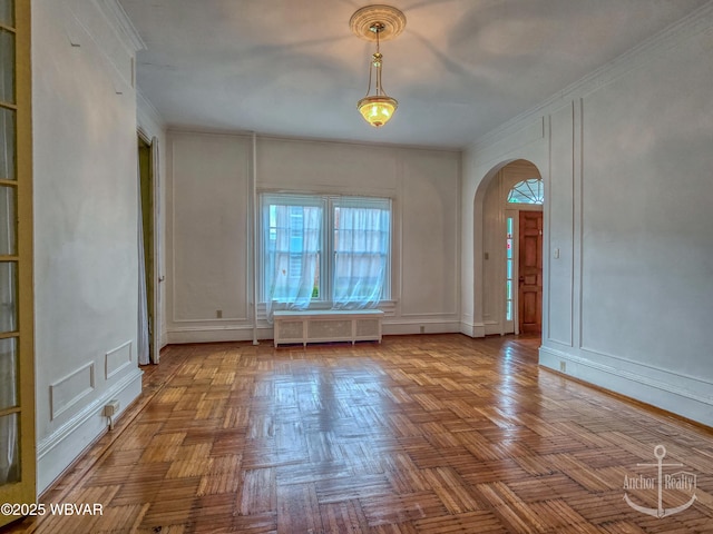 345 W Main St, Lock Haven, PA 17745 - empty room featuring a decorative wall, radiator heating unit, arched walkways, and crown molding