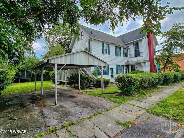 345 W Main St, Lock Haven, PA 17745 - view of side of home with a trampoline, stairway, a lawn, driveway, and a shingled roof