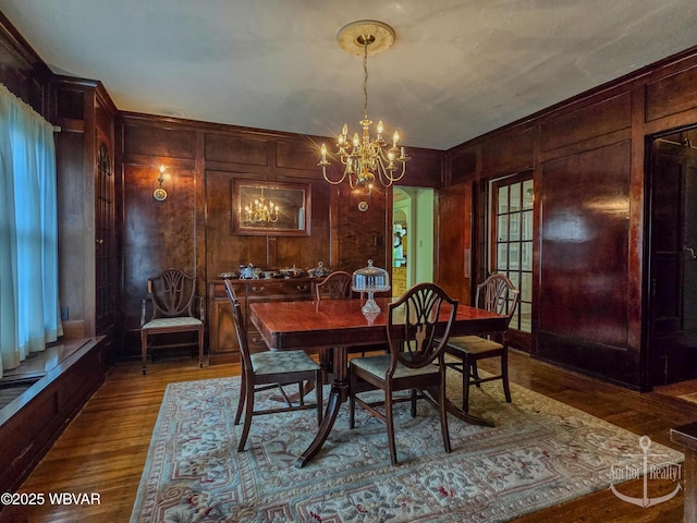 345 W Main St, Lock Haven, PA 17745 - dining room featuring wood finished floors, wood walls, and a chandelier