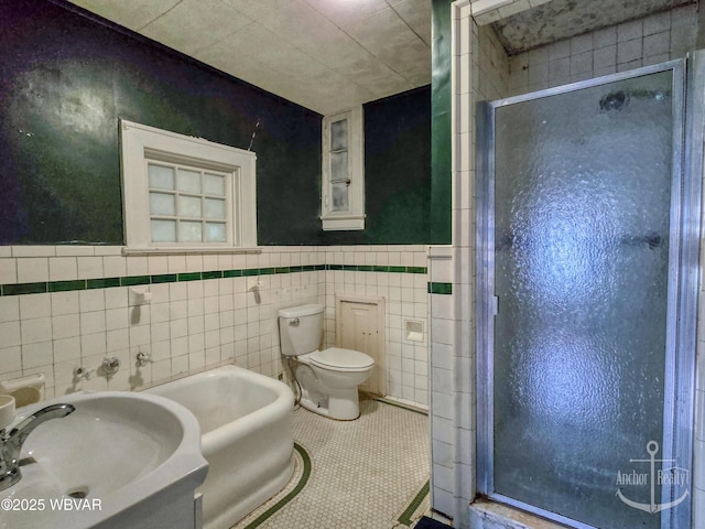 345 W Main St, Lock Haven, PA 17745 - full bath featuring a shower stall, tile walls, tile patterned flooring, and a wainscoted wall