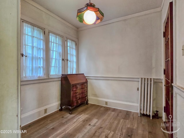 345 W Main St, Lock Haven, PA 17745 - empty room featuring wood finished floors, radiator, and crown molding