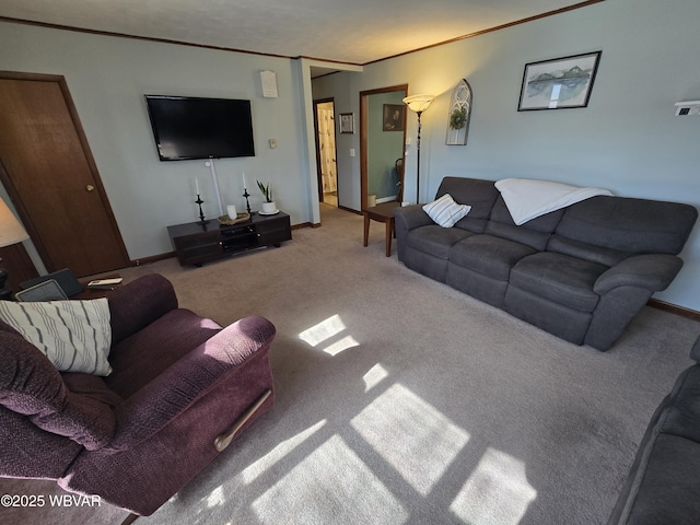 living area featuring carpet flooring, baseboards, and crown molding