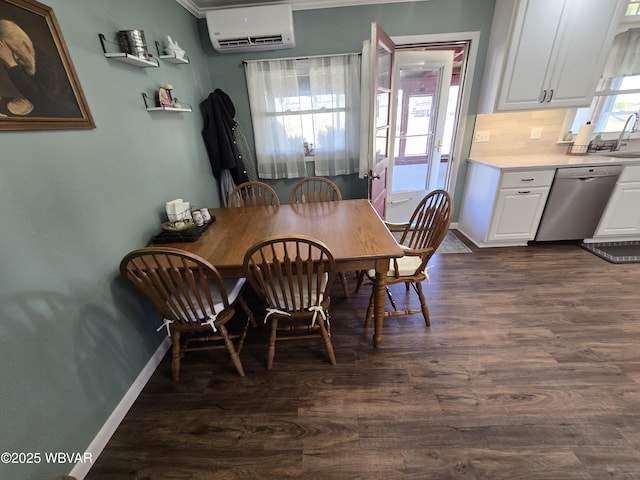 dining area with dark wood finished floors, an AC wall unit, and baseboards