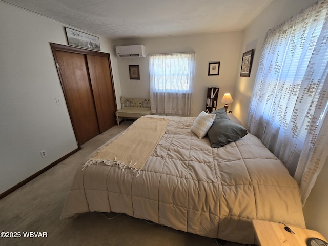 carpeted bedroom featuring baseboards, a closet, and a wall mounted air conditioner