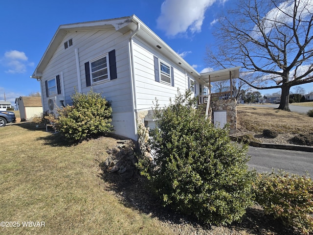 view of side of home featuring a lawn