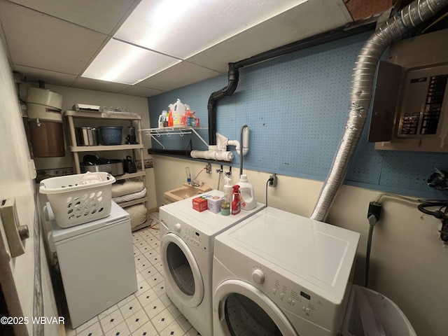 laundry room with electric panel, light floors, independent washer and dryer, and laundry area