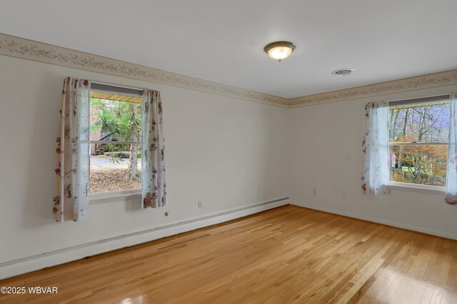 316 Winter St, Duboistown, PA 17702 - empty room featuring baseboard heating, baseboards, visible vents, and light wood-style flooring