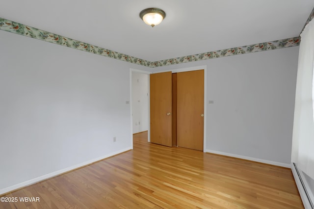 316 Winter St, Duboistown, PA 17702 - empty room with light wood-style flooring, baseboards, and a baseboard radiator