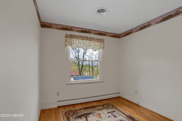 316 Winter St, Duboistown, PA 17702 - unfurnished room featuring a baseboard radiator, baseboards, visible vents, and light wood-type flooring