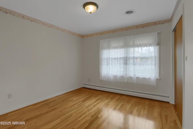 316 Winter St, Duboistown, PA 17702 - spare room featuring a baseboard heating unit, wood finished floors, and visible vents