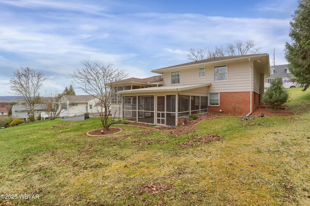 316 Winter St, Duboistown, PA 17702 - rear view of property featuring brick siding, a sunroom, and a lawn