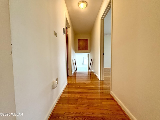 316 Winter St, Duboistown, PA 17702 - corridor featuring baseboards, wood finished floors, and an upstairs landing