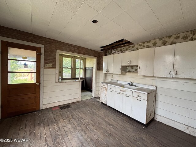 877-879 S 2nd St, Sunbury, PA 17801 - kitchen with dark wood-style flooring, white cabinets, and a sink