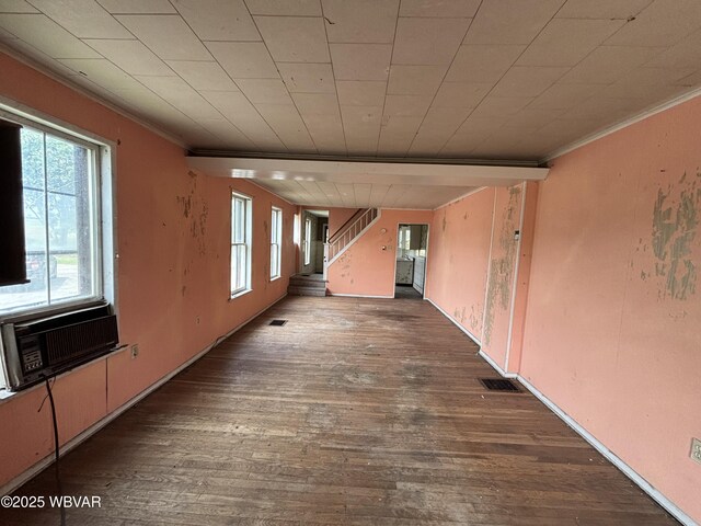 877-879 S 2nd St, Sunbury, PA 17801 - empty room featuring crown molding, healthy amount of natural light, hardwood / wood-style floors, cooling unit, and stairway
