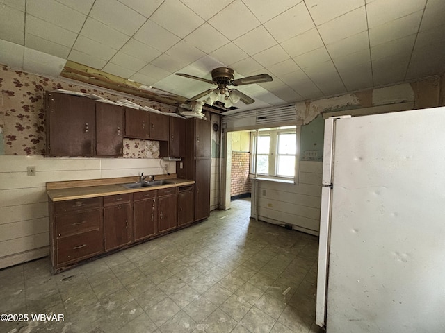 877-879 S 2nd St, Sunbury, PA 17801 - kitchen featuring freestanding refrigerator, a sink, light flooring, wallpapered walls, and a ceiling fan