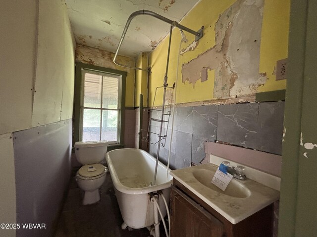 877-879 S 2nd St, Sunbury, PA 17801 - full bath with a freestanding bath, tile walls, vanity, toilet, and wainscoting