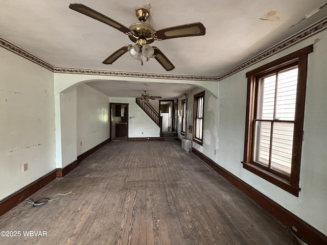 877-879 S 2nd St, Sunbury, PA 17801 - unfurnished living room with arched walkways, ceiling fan, wood-type flooring, baseboards, and crown molding