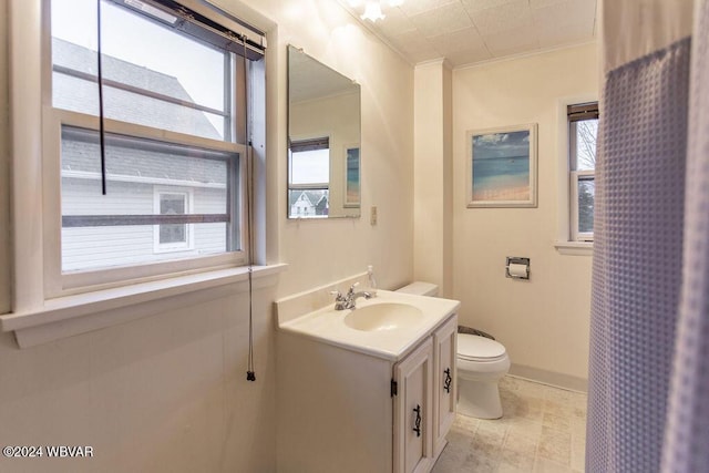 bathroom featuring vanity, toilet, and crown molding