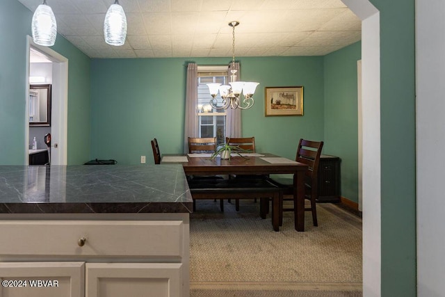 dining area featuring carpet flooring and a chandelier