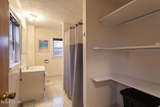 bathroom with vanity, curtained shower, and toilet