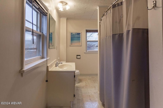 bathroom featuring a shower with curtain, vanity, and toilet