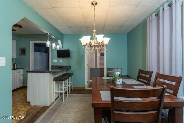 dining room featuring dark wood-type flooring and a chandelier