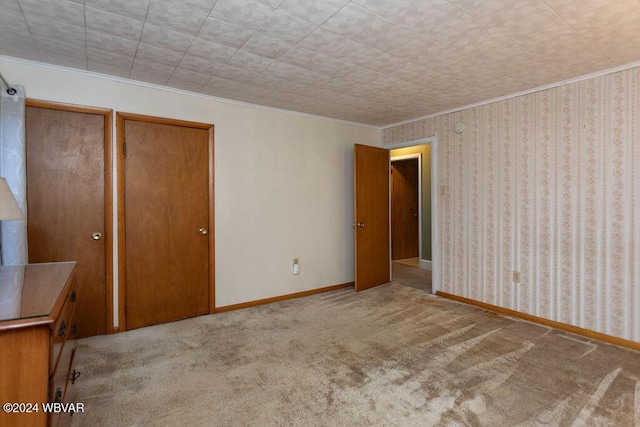 unfurnished bedroom with light carpet and ornamental molding