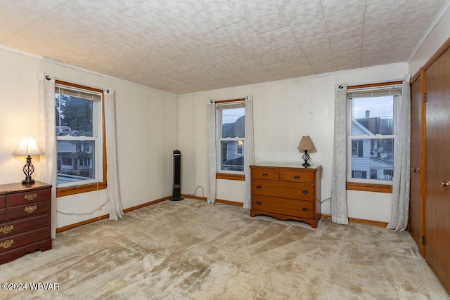 carpeted bedroom with ornamental molding