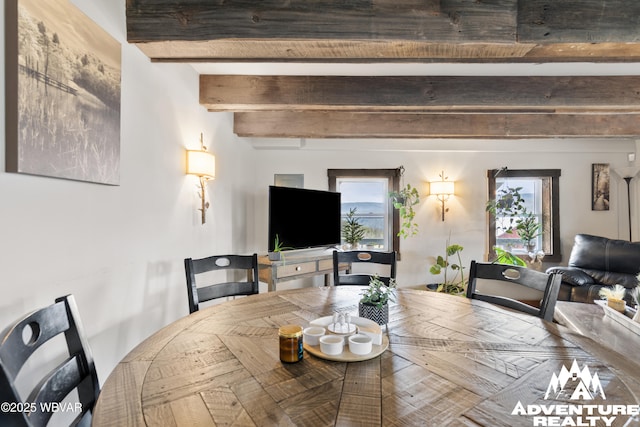 dining area featuring beam ceiling