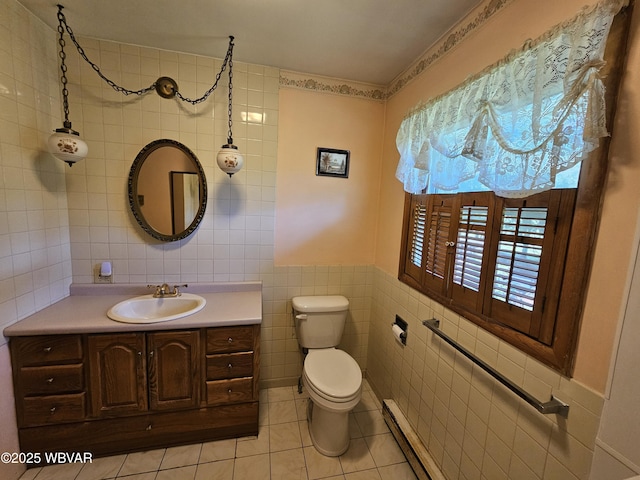 399 Sholder Rd, Williamsport, PA 17701 - bathroom featuring tile walls, a baseboard heating unit, vanity, toilet, and tile patterned flooring