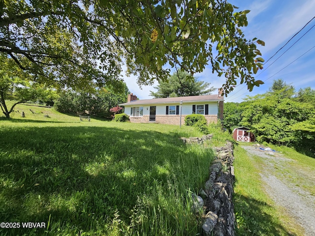 399 Sholder Rd, Williamsport, PA 17701 - ranch-style home with a chimney, a front yard, and driveway