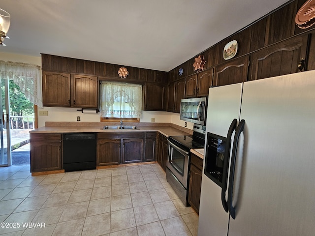 399 Sholder Rd, Williamsport, PA 17701 - kitchen featuring stainless steel appliances, a sink, light countertops, and light tile patterned floors