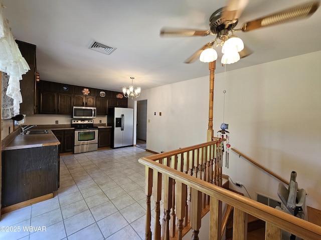 399 Sholder Rd, Williamsport, PA 17701 - kitchen featuring appliances with stainless steel finishes, a chandelier, a sink, ceiling fan, and light tile patterned floors
