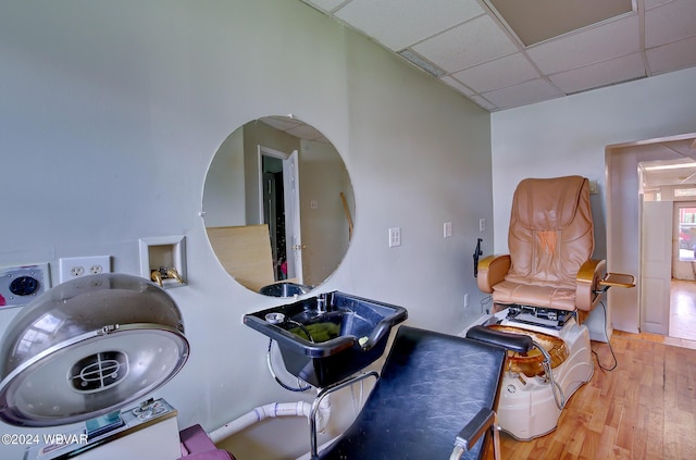 bathroom featuring hardwood / wood-style flooring and a drop ceiling