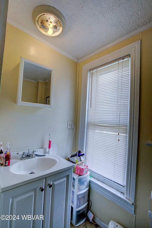 bathroom featuring vanity, a textured ceiling, and ornamental molding