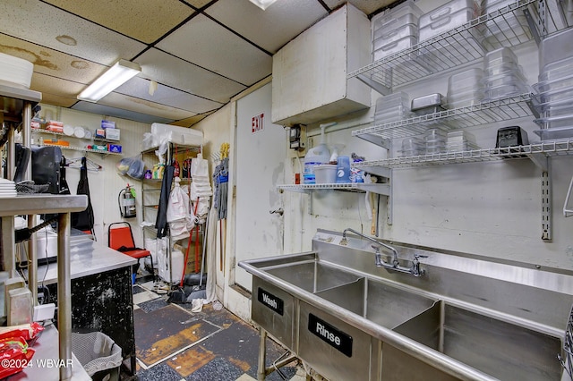 kitchen featuring a paneled ceiling and sink