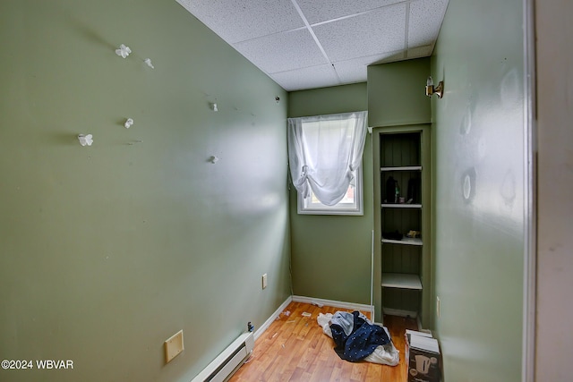 empty room with a paneled ceiling and hardwood / wood-style flooring