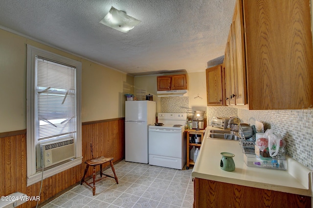 kitchen featuring backsplash, a textured ceiling, white appliances, cooling unit, and sink