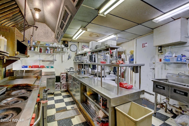 kitchen featuring a drop ceiling and stainless steel counters