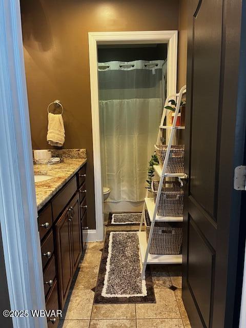 bathroom with tile patterned floors, vanity, and a shower with shower curtain