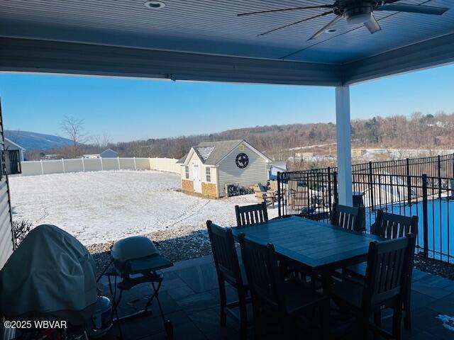 view of patio / terrace featuring grilling area, an outdoor structure, and ceiling fan