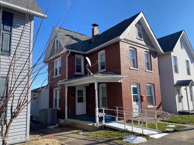 view of front of home with central AC and a porch