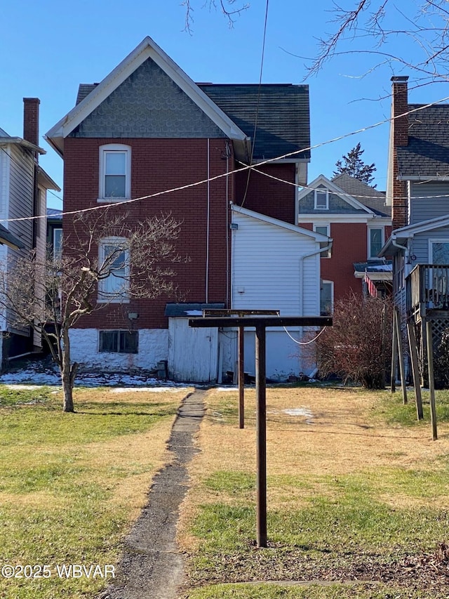 rear view of house with a lawn